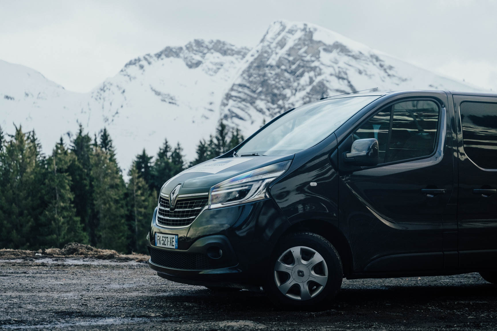 Snowytrees private transfer minibus with snowy mountains behind